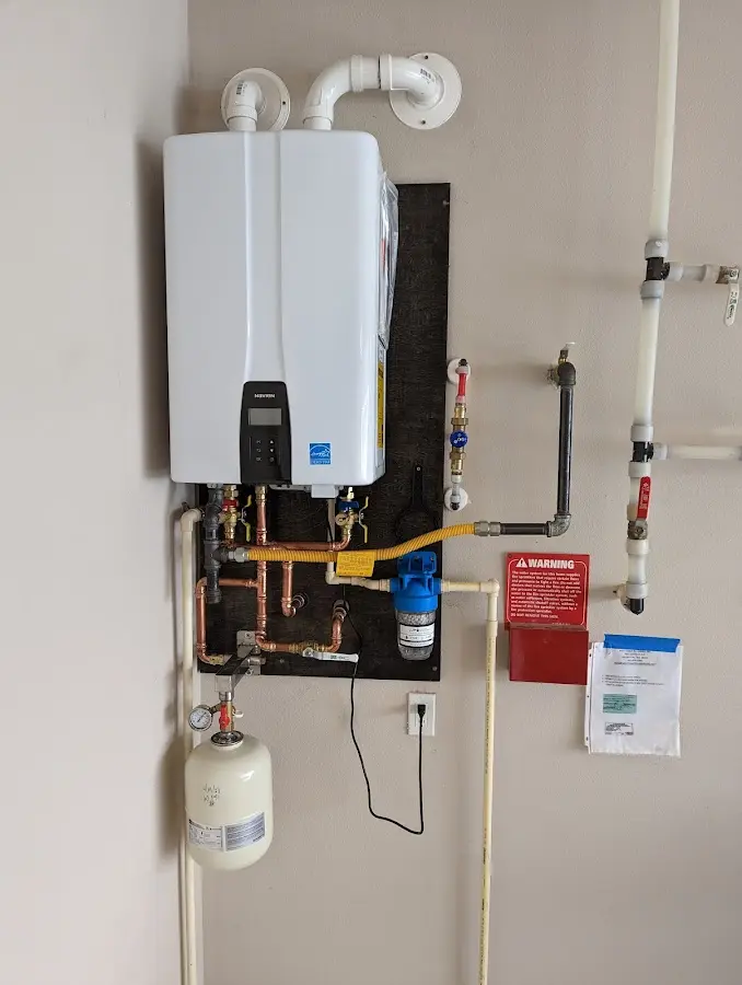 Professional plumber installing copper piping in a Marblehead home